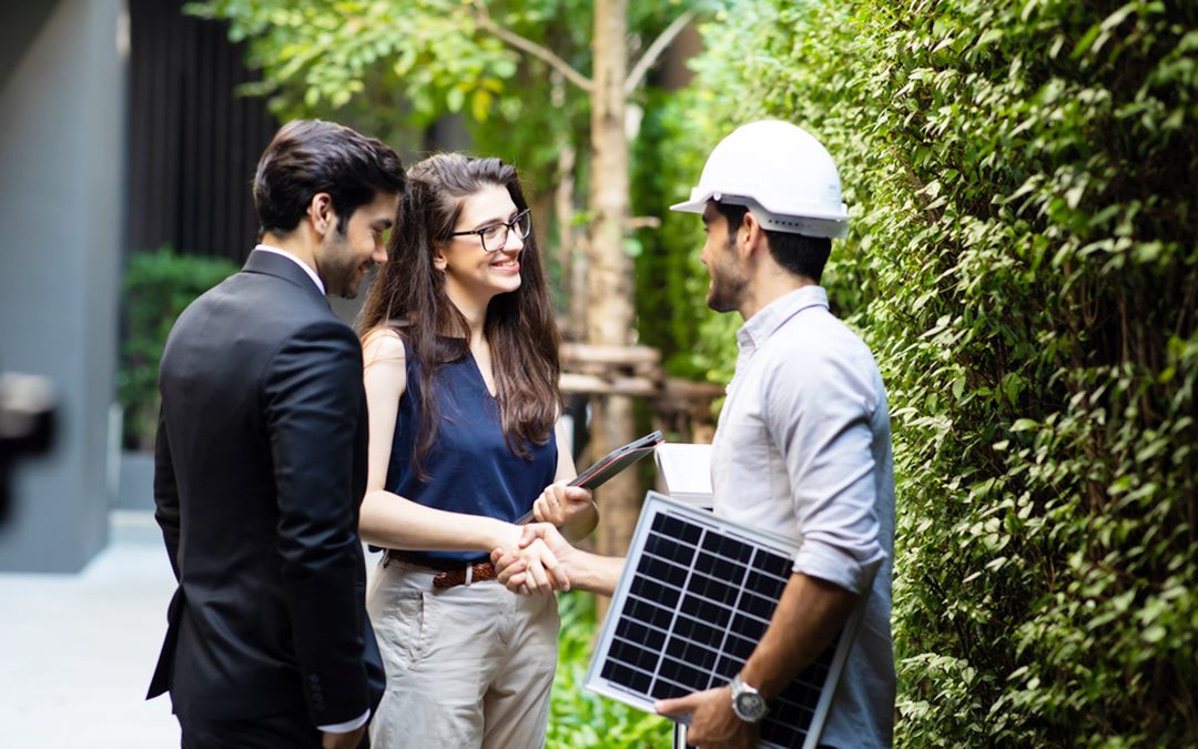 People working for alternative energy with wind turbine and solar panel while wearing face mask